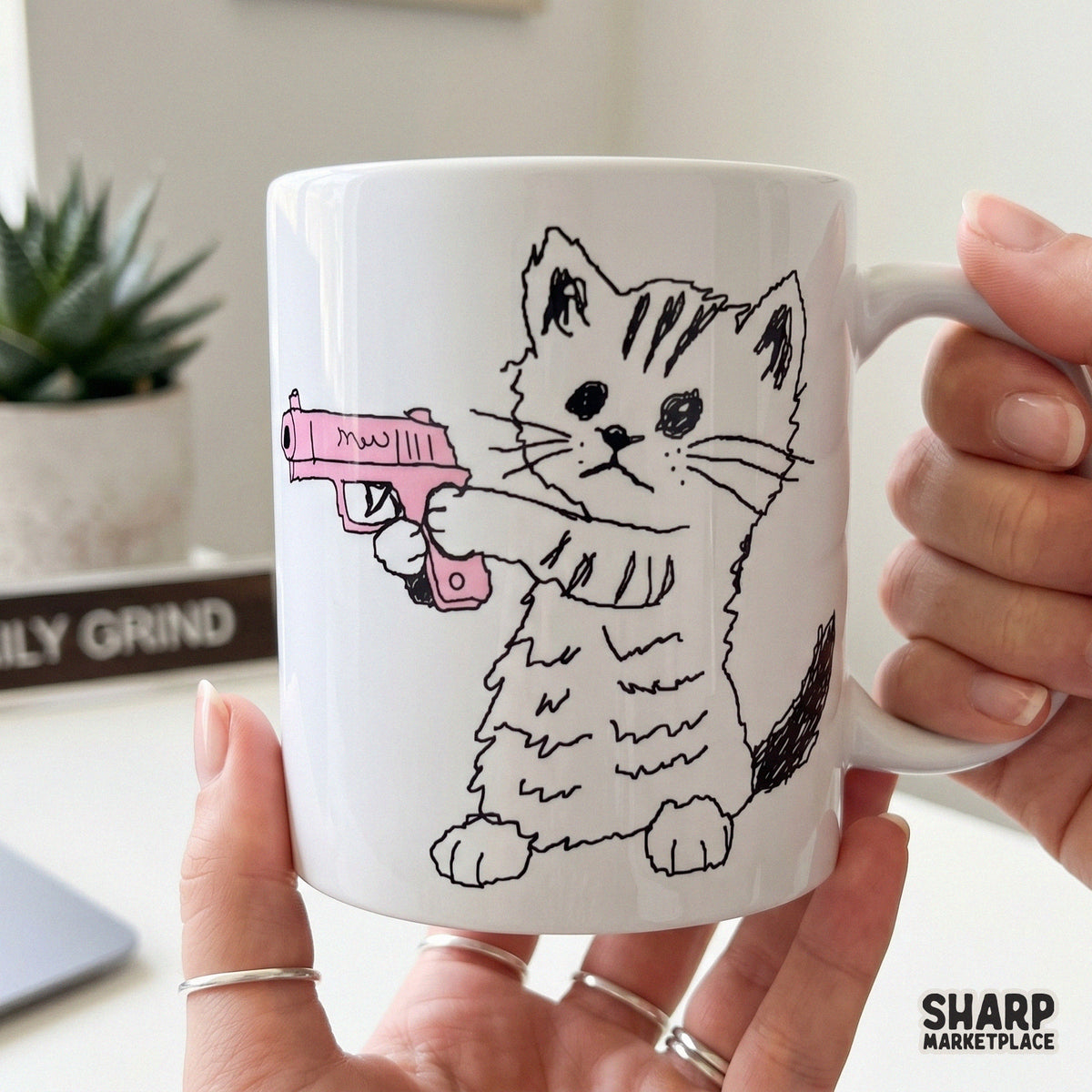 Playful digital illustration of a tiny kitten holding a pink toy blaster, rendered in a loose sketch style for unique print on demand products.
