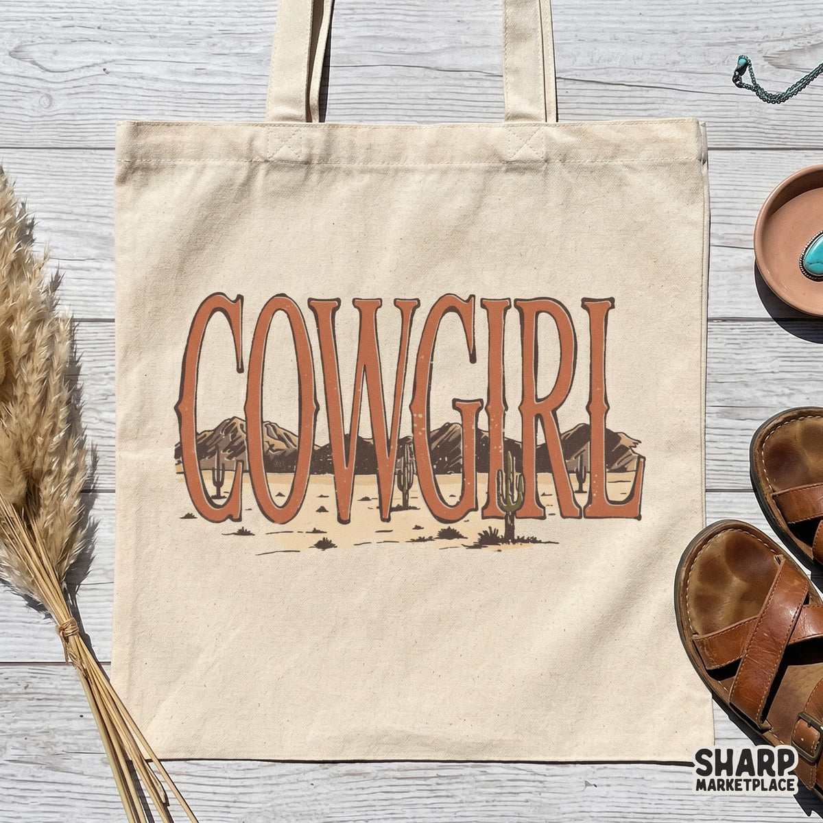 Boho western style Cowgirl text design with a detailed desert mountain and cactus landscape, ideal for t-shirt printing and sublimation.