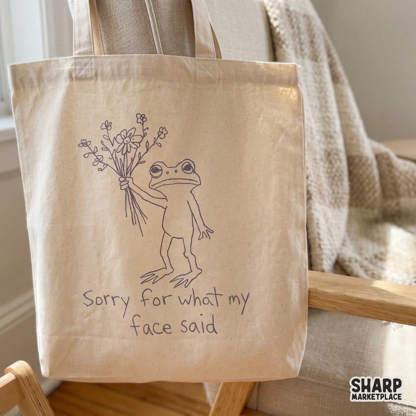 Digital graphic of a grumpy frog holding flowers with the sarcastic text Sorry for what my face said, suitable for DIY gifts, tumblers, and wall art.