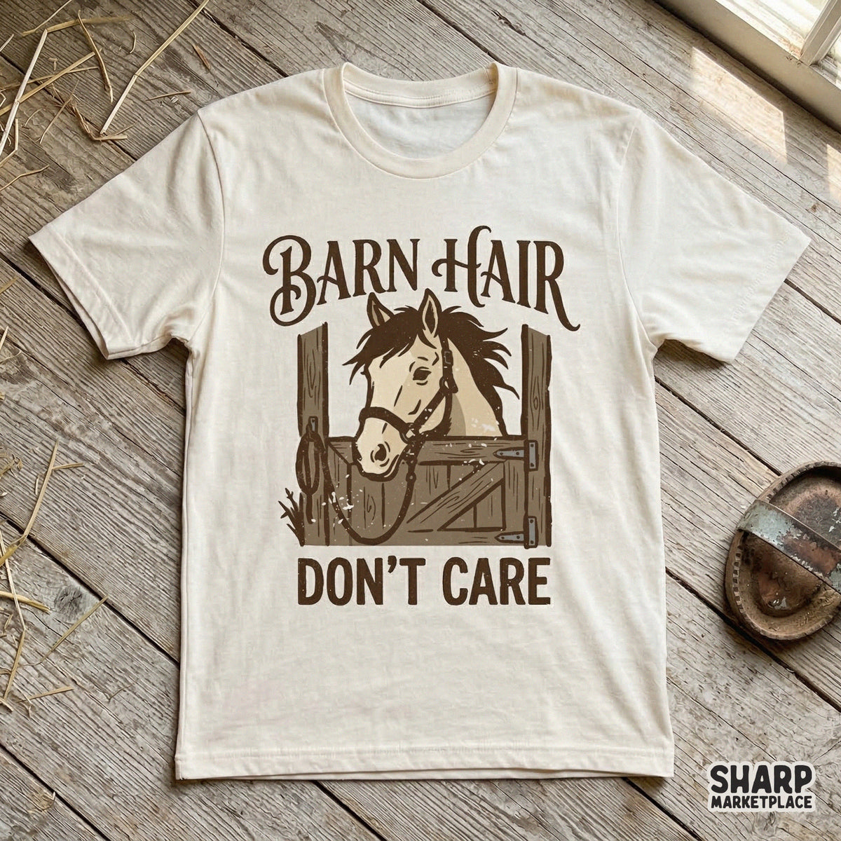 Cream colored t-shirt mockup displaying a rustic horse illustration with the text Barn Hair Don't Care in a vintage western style.