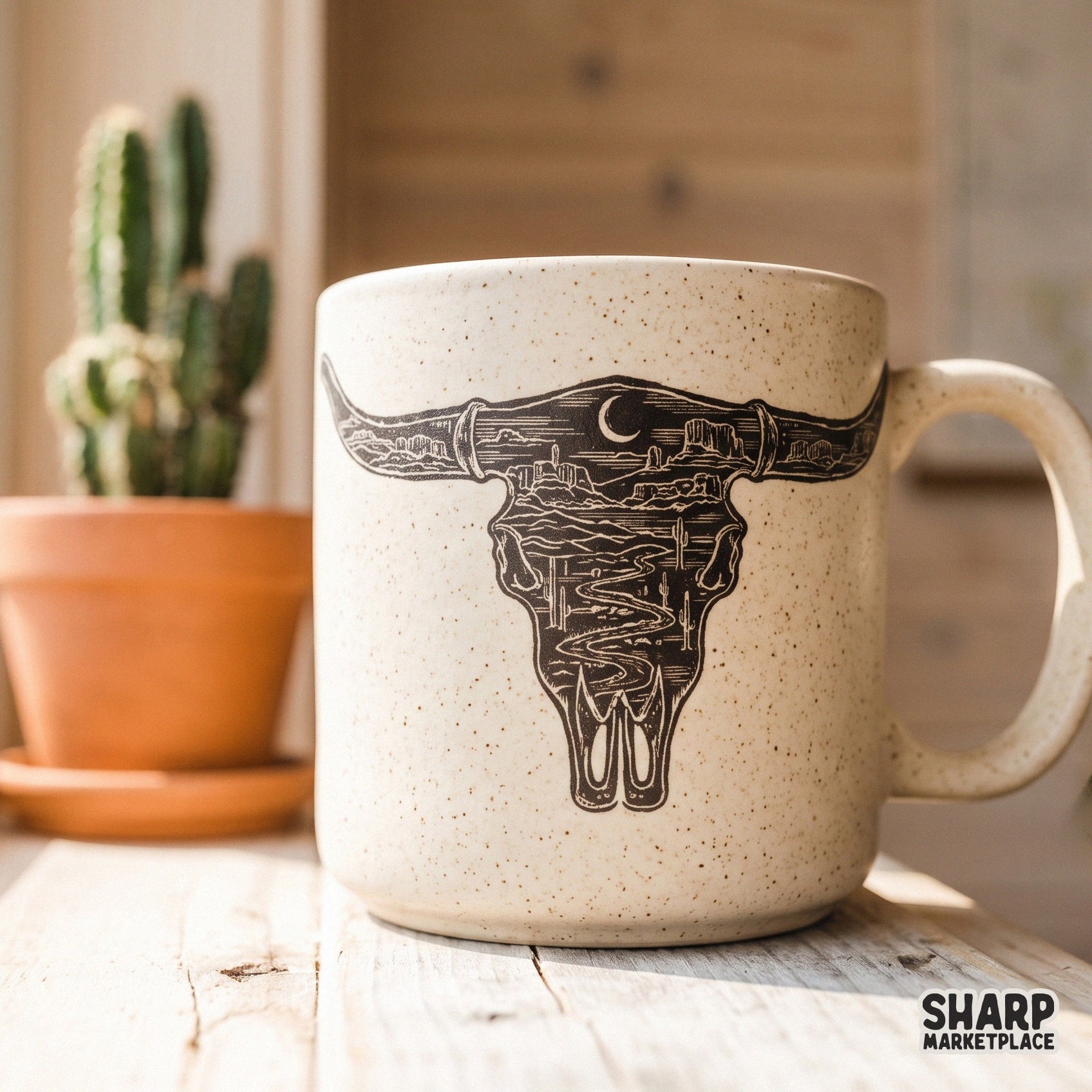 Vintage bull skull illustration with a desert landscape and cacti, perfect for western boho and country music shirt designs