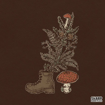 Vintage hiking boot design with growing ferns and red mushrooms for retro nature shirt prints and camping PNG sublimation