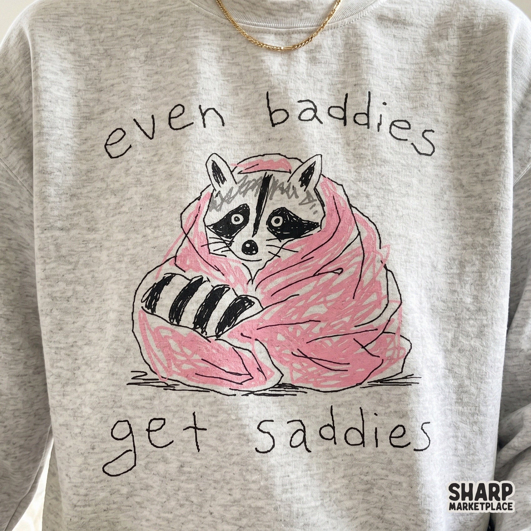 Cute, relatable raccoon design featuring a cozy pink blanket and handwritten typography, suitable for creating unique apparel and mental health art.