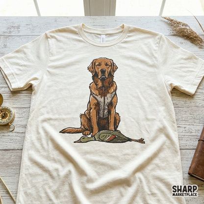 Detailed retriever and duck hunting illustration printed on a cream colored t-shirt, perfect for outdoor themed apparel and western style designs.