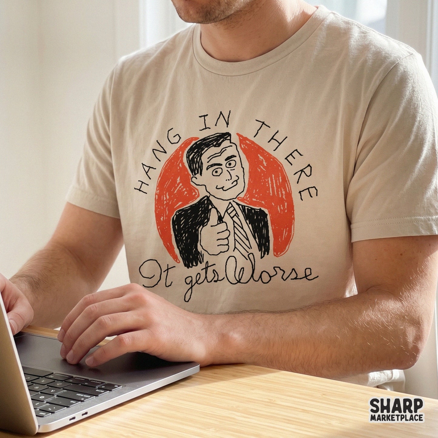 Digital design for apparel featuring a cynical office worker giving a thumbs up with the sarcastic quote Hang In There It Gets Worse in a retro sketch style.