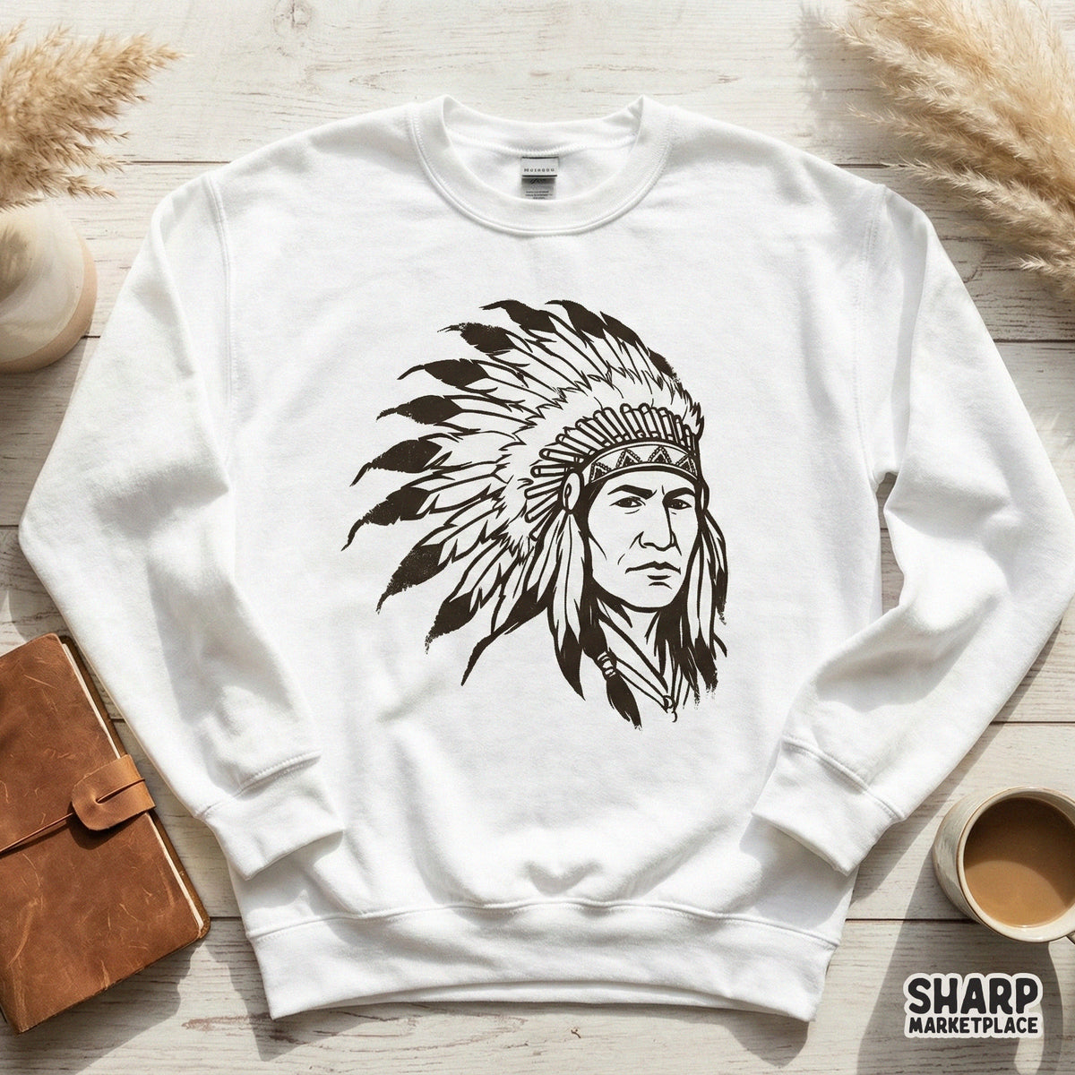 White sweatshirt featuring a black, hand-drawn portrait of an indigenous leader in a tribal headdress, suitable for custom apparel and sublimation printing.