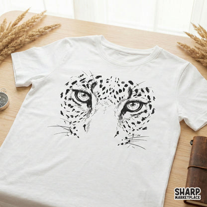 Minimalist black and white leopard eyes design printed on a white t-shirt, showcasing a bold, hand-drawn big cat aesthetic for apparel.