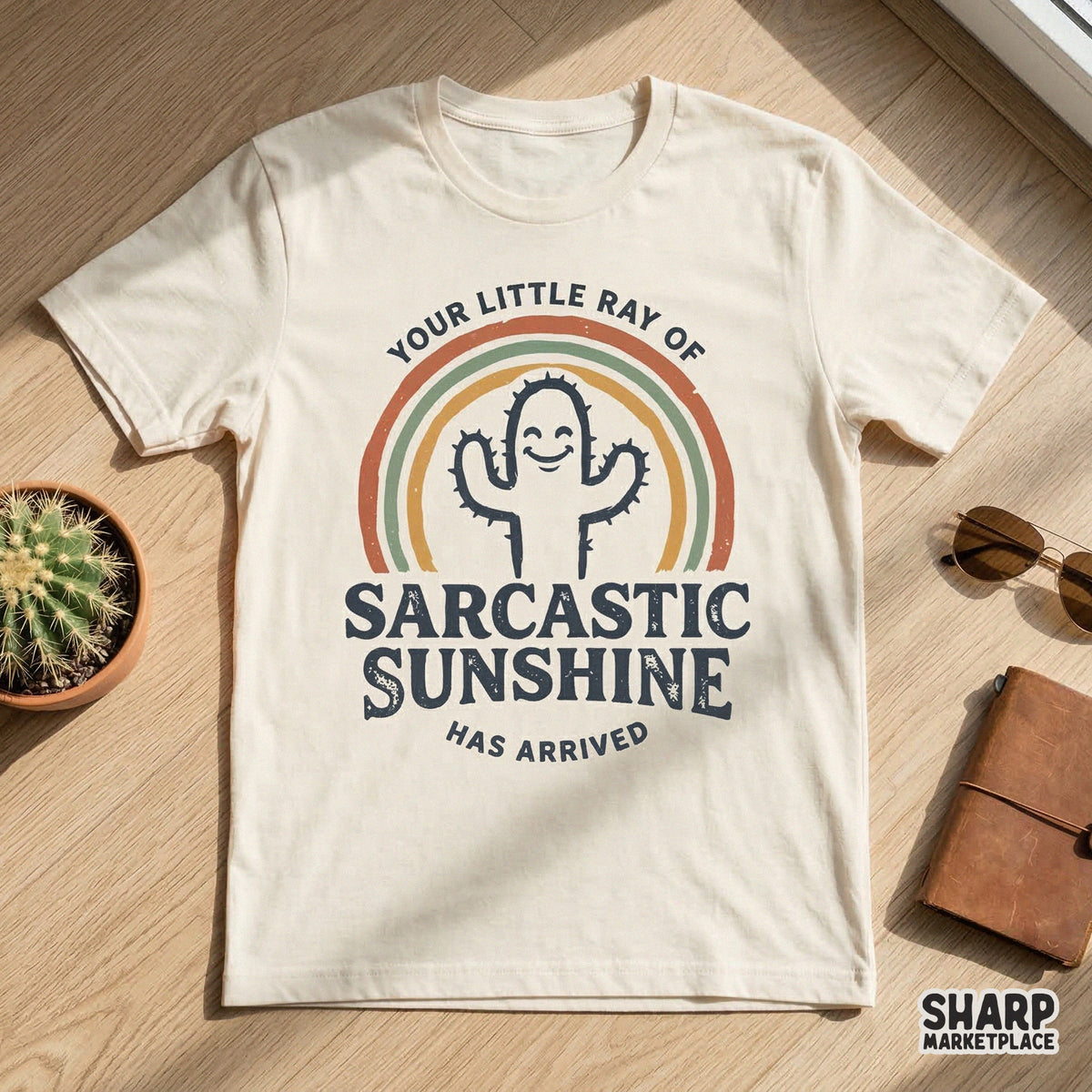 Funny cactus sublimation design with a retro rainbow and the text Your Little Ray Of Sarcastic Sunshine Has Arrived for apparel or stickers.