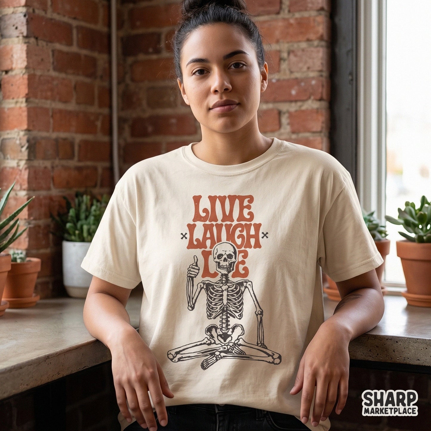 Retro sitting skeleton with Live Laugh Die text in a sarcastic vintage style for Halloween apparel and spooky decor pins