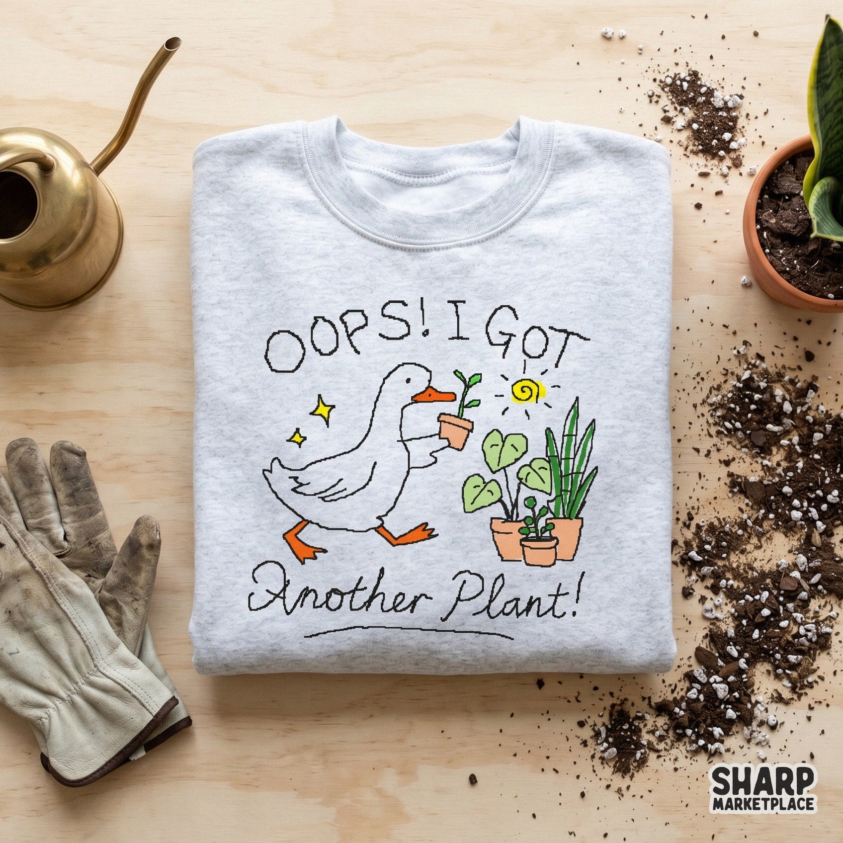 Cute goose gardener artwork with the text Oops! I Got Another Plant! featuring yellow sparkles and potted plants for trendy apparel printing.