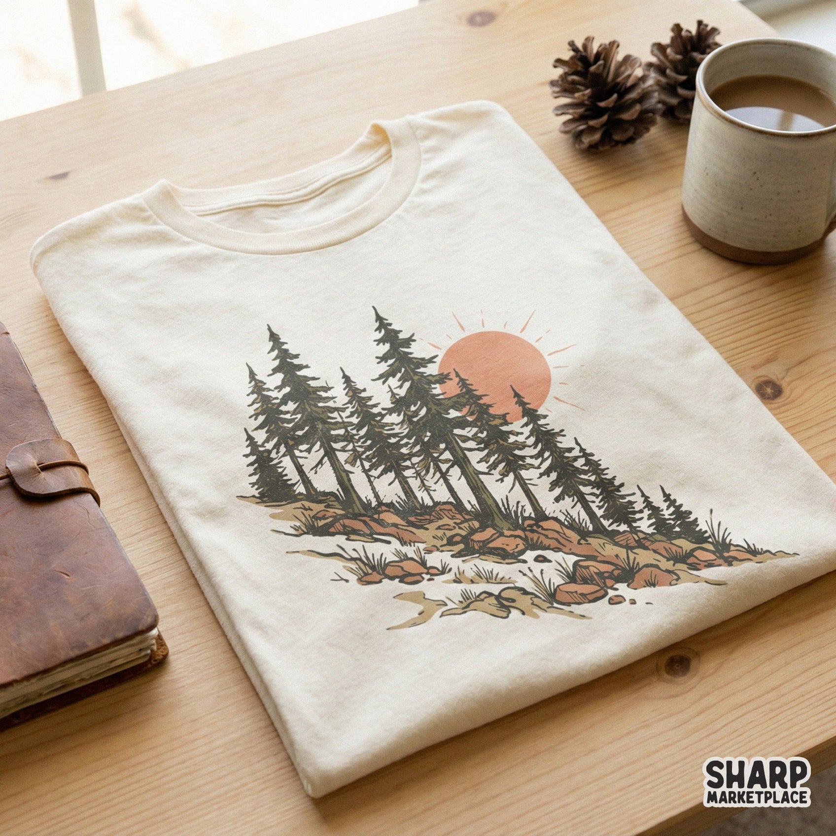 Vintage-style mountain pine tree illustration with a warm sun, featured as a digital design on a cream-colored t-shirt for outdoor enthusiasts.