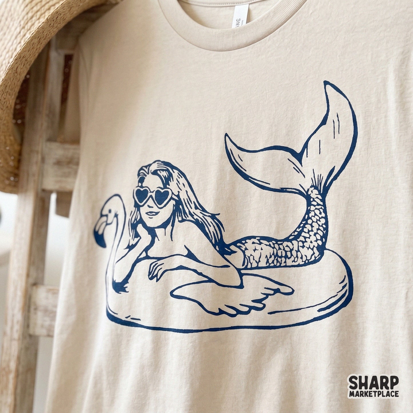 Vintage mermaid on a flamingo pool float with heart sunglasses, retro sublimation graphic for a trendy summer beach shirt