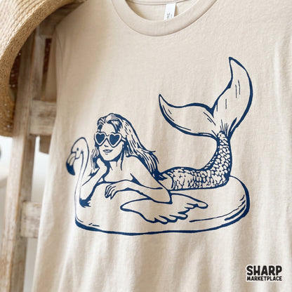 Vintage mermaid on a flamingo pool float with heart sunglasses, retro sublimation graphic for a trendy summer beach shirt