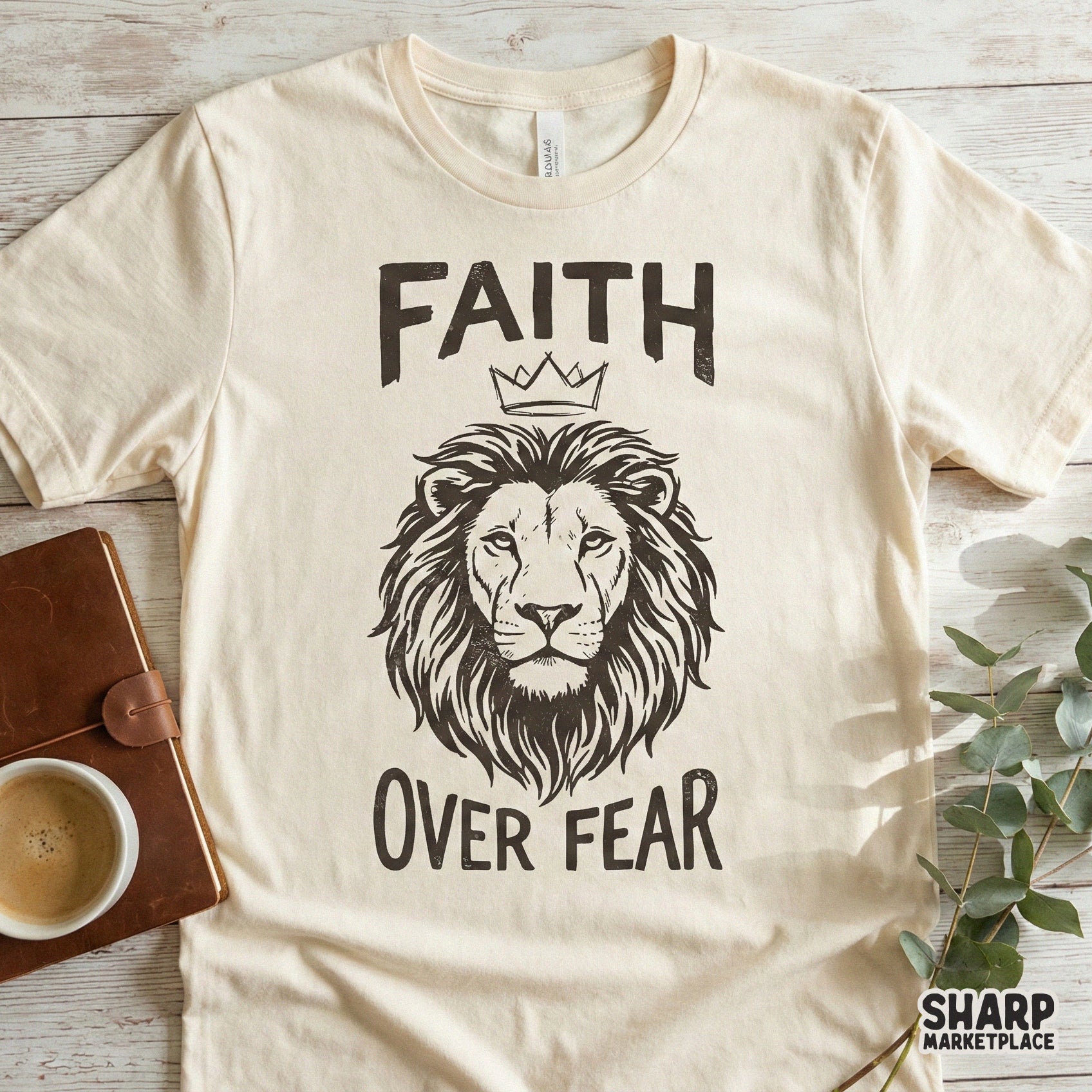 Faith Over Fear graphic on a t-shirt mockup, showcasing a distressed monochromatic lion illustration with a crown for custom apparel printing.