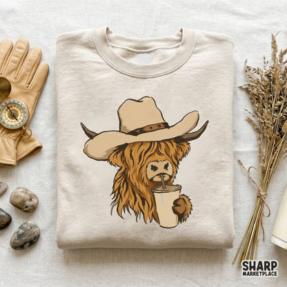Digital PNG graphic of a cute highland cow with rustic horns and a cowboy hat, perfect for western-themed t-shirts, stickers, or custom apparel.