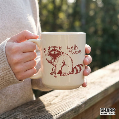Whimsical raccoon design with handwritten hello there text, created in a vintage ink style for stickers, tumblers, and nature-inspired projects.