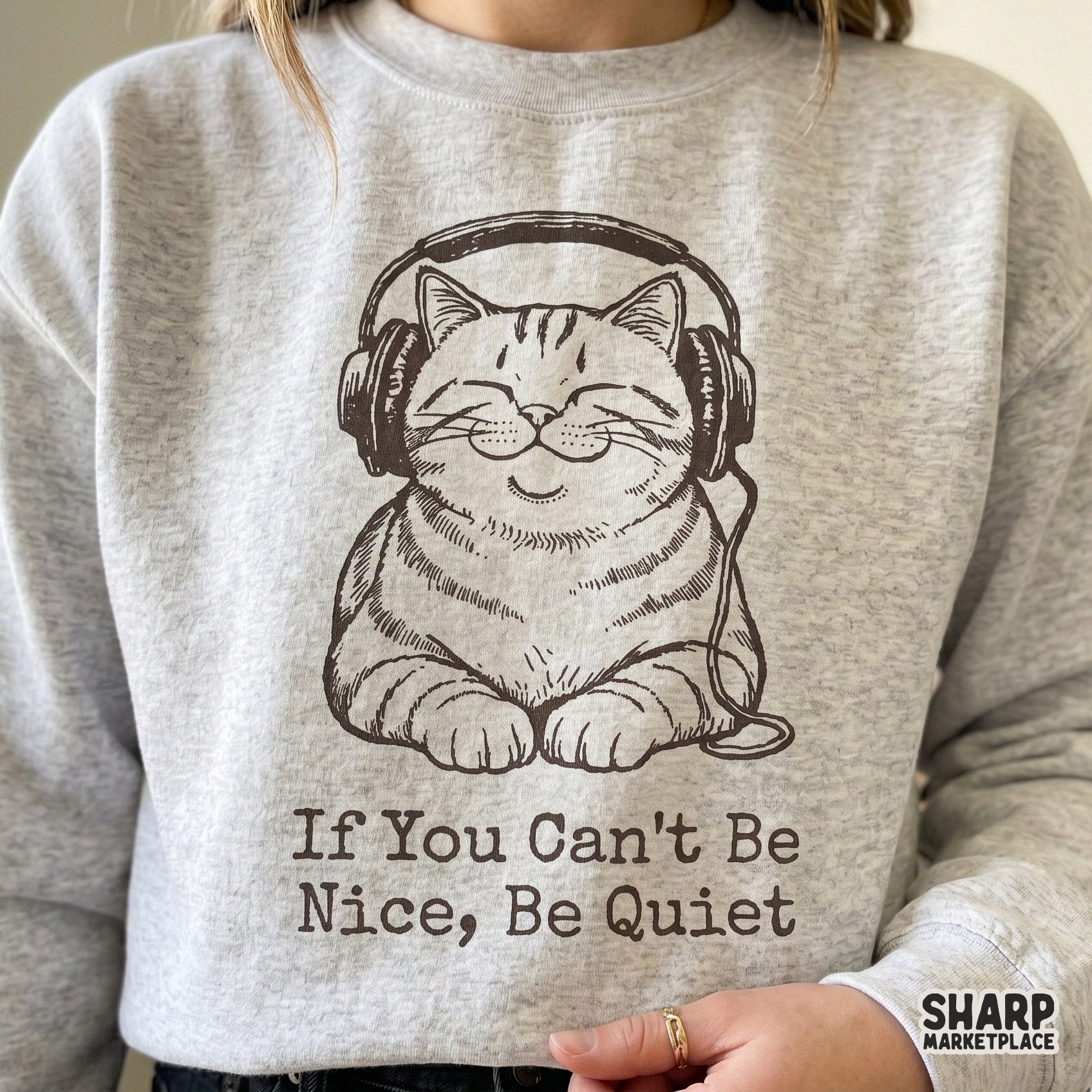 A digital design featuring a content cat in headphones with the sarcastic quote If You Can't Be Nice, Be Quiet, perfect for apparel sublimation.