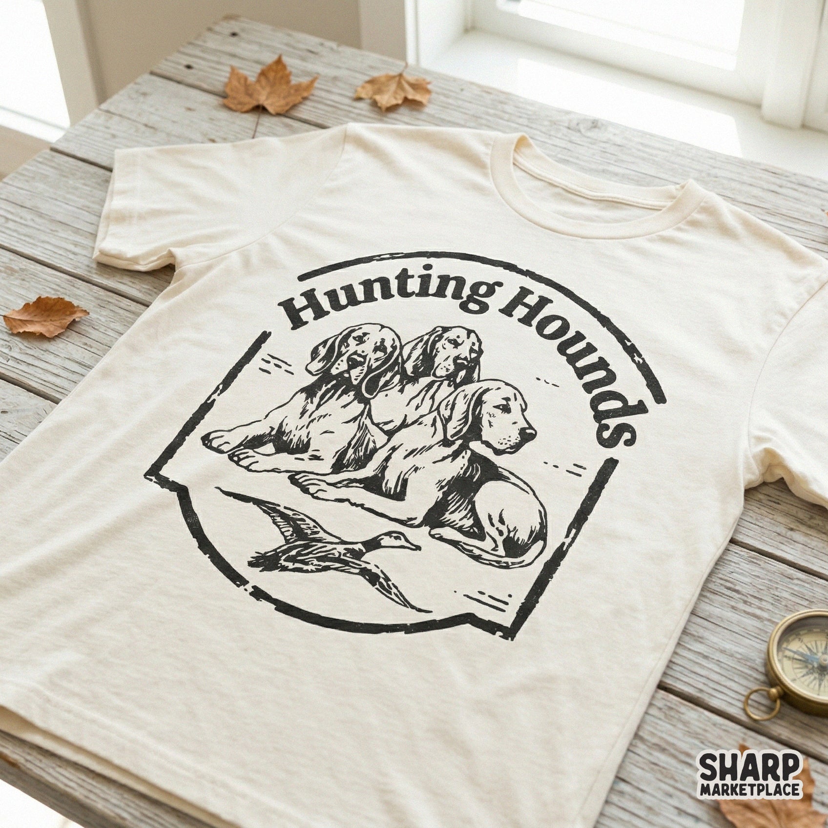 Rustic Hunting Hounds digital design printed on a t-shirt, showcasing a detailed illustration of three dogs and a duck in a distressed circular frame.