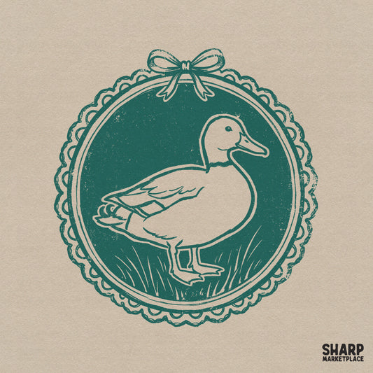 Vintage teal and cream duck cameo illustration featuring a mallard inside a scalloped lace frame with a dainty bow, perfect for cottagecore apparel.