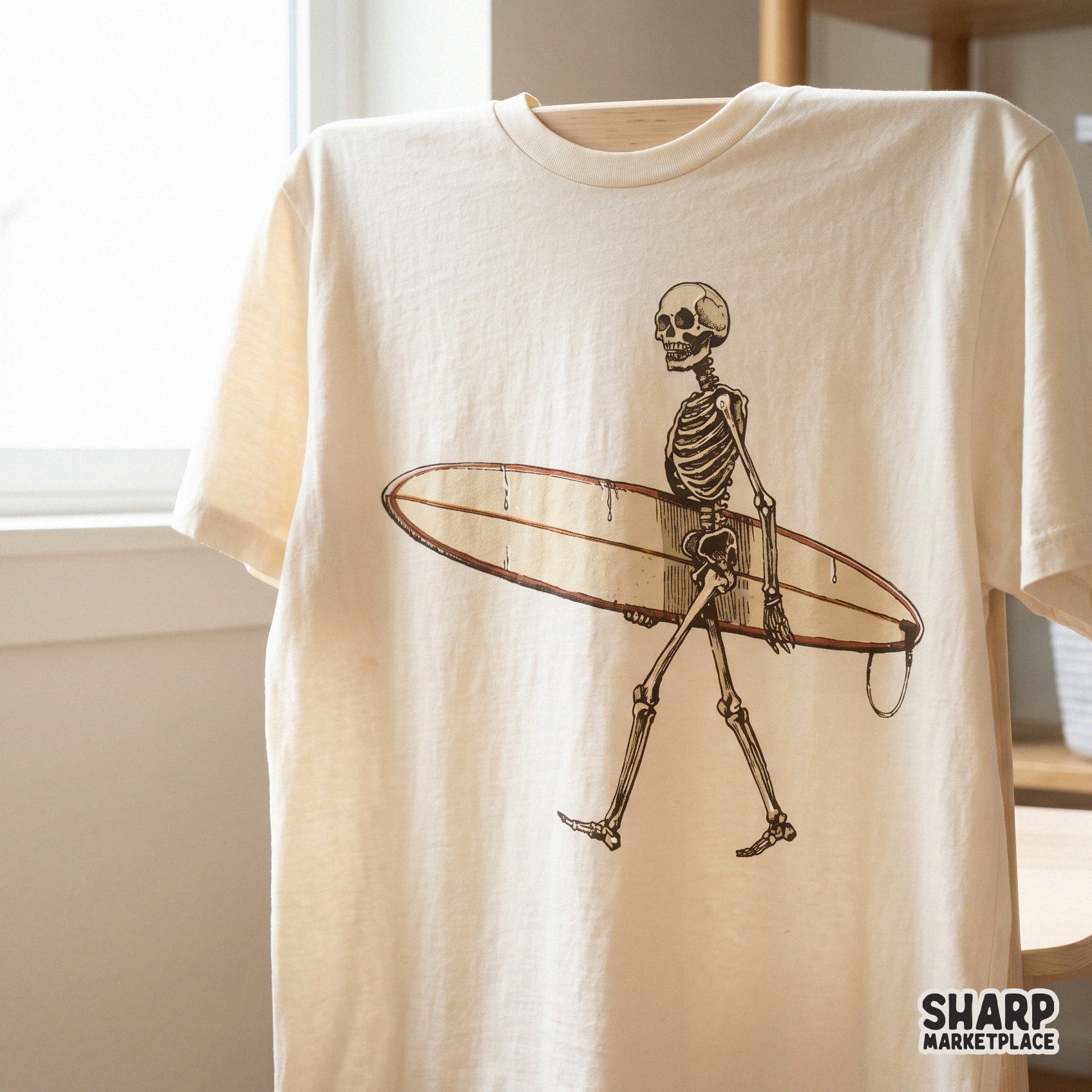 Retro surfing skeleton design on a cream t-shirt, showcasing a moody beach aesthetic perfect for custom apparel or sublimation projects.