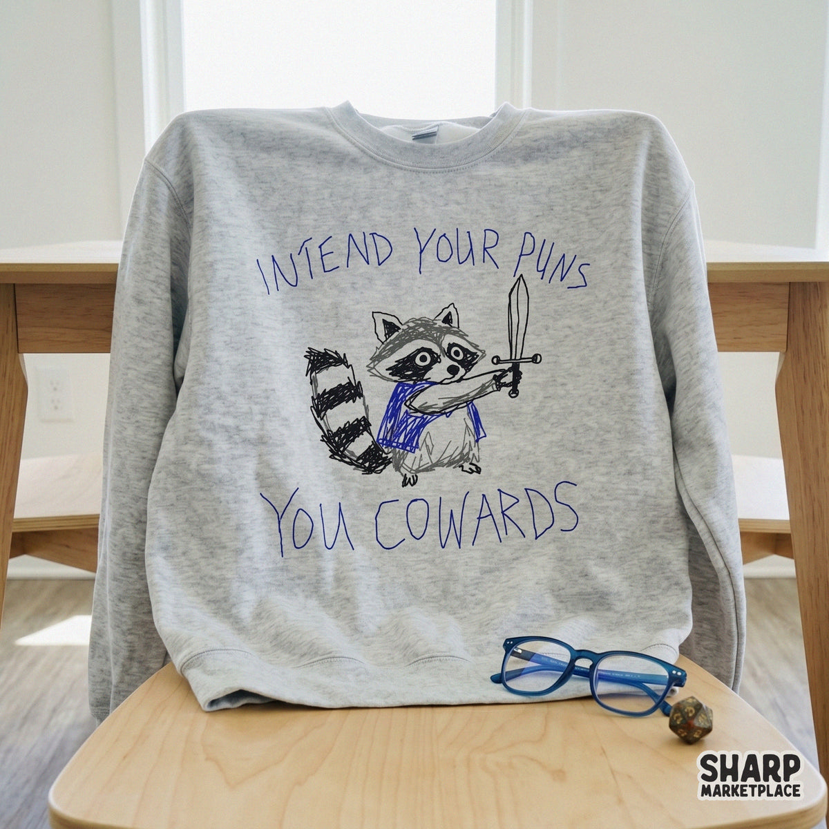 Digital design file featuring a funny, messy sketch of a raccoon knight brandishing a sword with the sarcastic quote Intend Your Puns You Cowards.