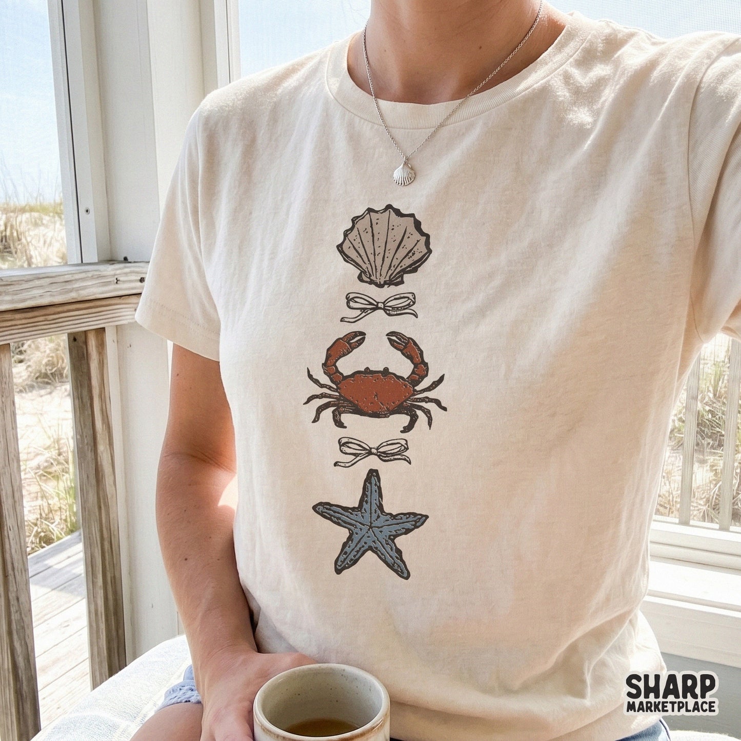 Hand-drawn seaside trio graphic featuring a textured shell, orange crab, and blue starfish, ideal for custom stickers, tumblers, and coastal decor.
