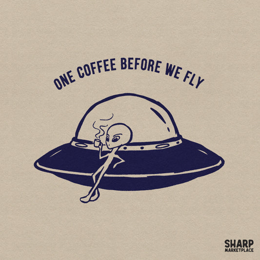 Minimalist dark blue line art of an alien leaning against a UFO while drinking coffee, with the arched text One Coffee Before We Fly above it.