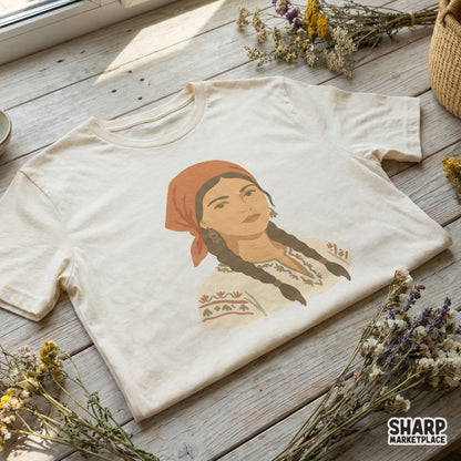 Boho style illustration of a girl in traditional ethnic clothing with floral embroidery, featured as a digital design on a cream colored t-shirt mockup.