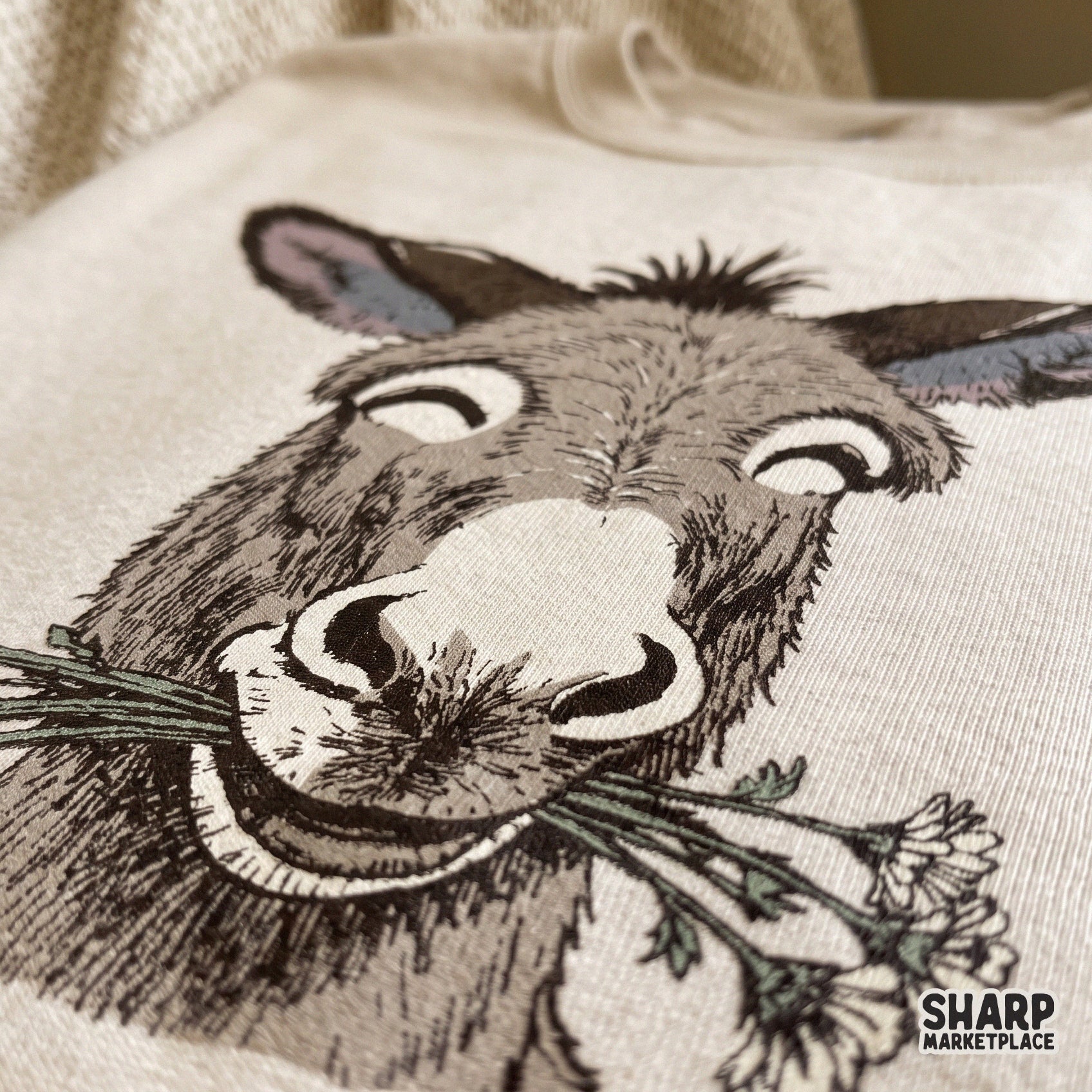 Funny smiling donkey face with daisy flowers in a retro spring sublimation design for animal lovers t-shirts and crafts