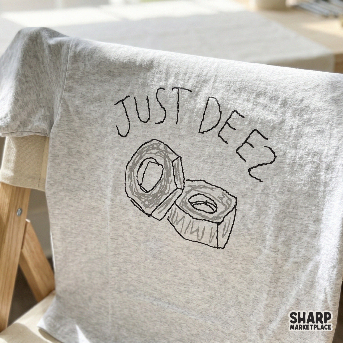 Minimalist black and white hardware pun design with two nuts and the phrase Just Deez, ideal for creating DIY sarcastic gifts and apparel.