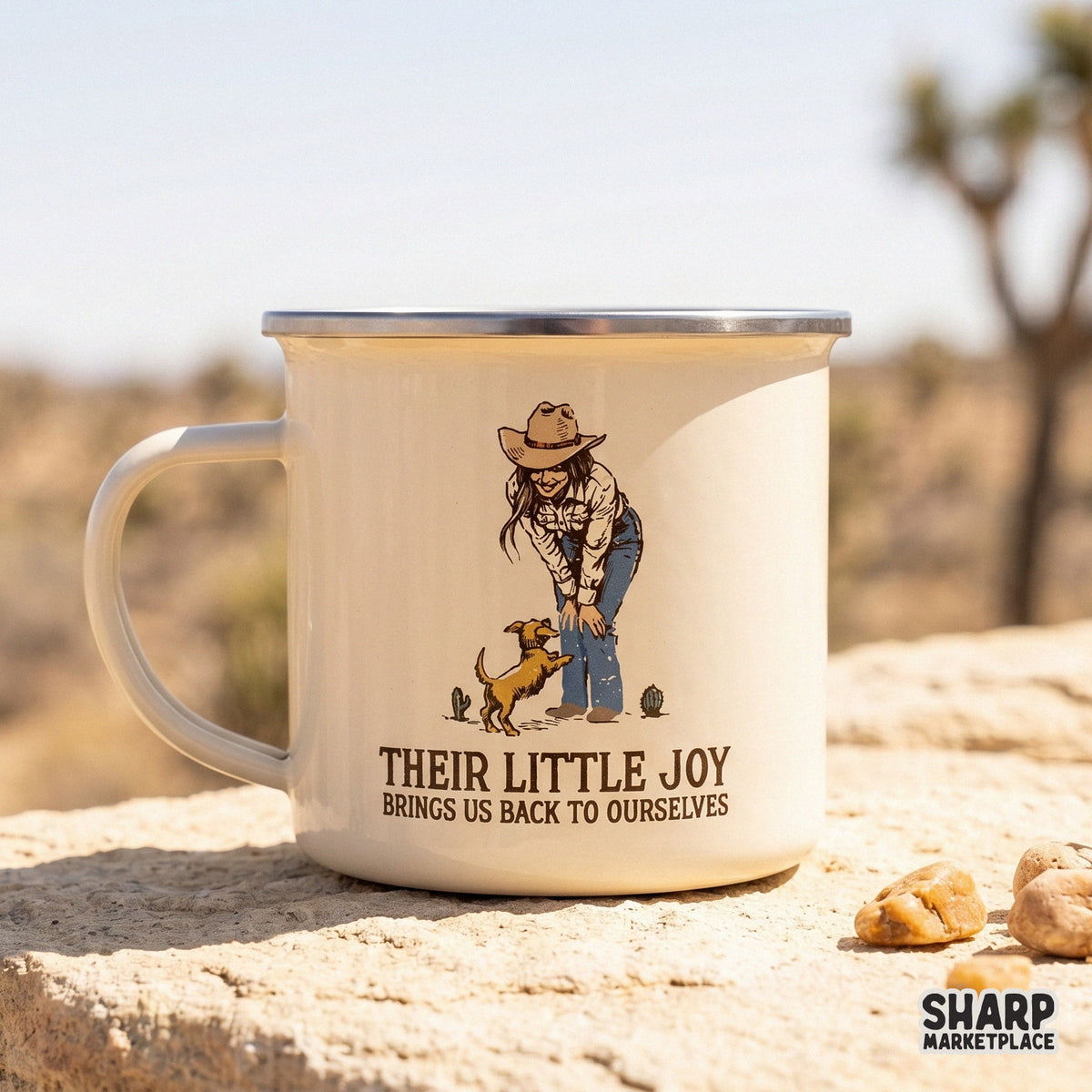 Cream-colored enamel mug featuring a western digital design of a cowgirl and her dog with the text Their Little Joy Brings Us Back To Ourselves.