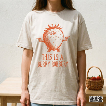 A vintage orange sketch of a grumpy strawberry character wielding two guns with the punny text This Is A Berry Robbery, perfect for t-shirt prints.