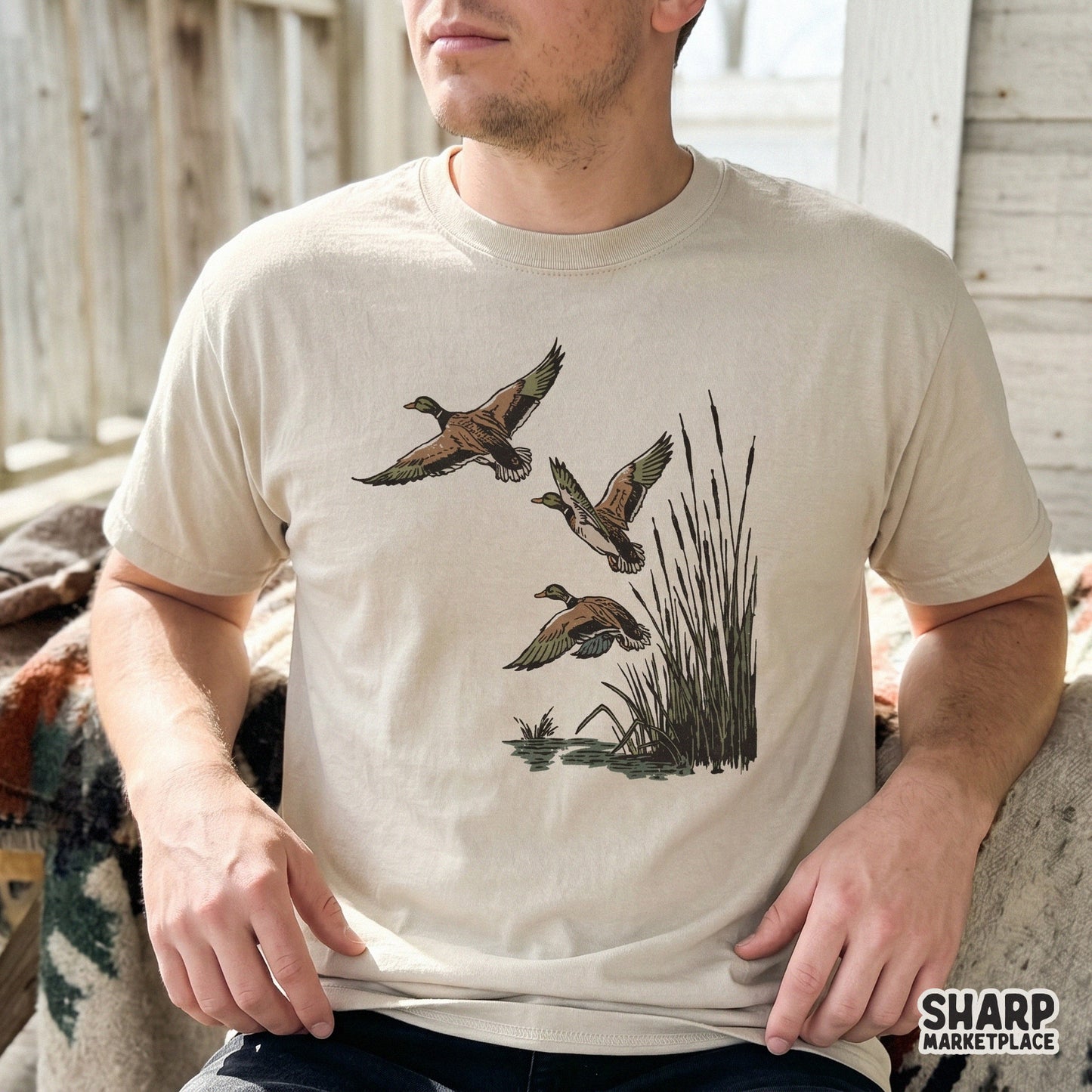 Three mallard ducks in flight above cattails and water, featured as a detailed digital graphic for custom t-shirt sublimation and outdoor decor.