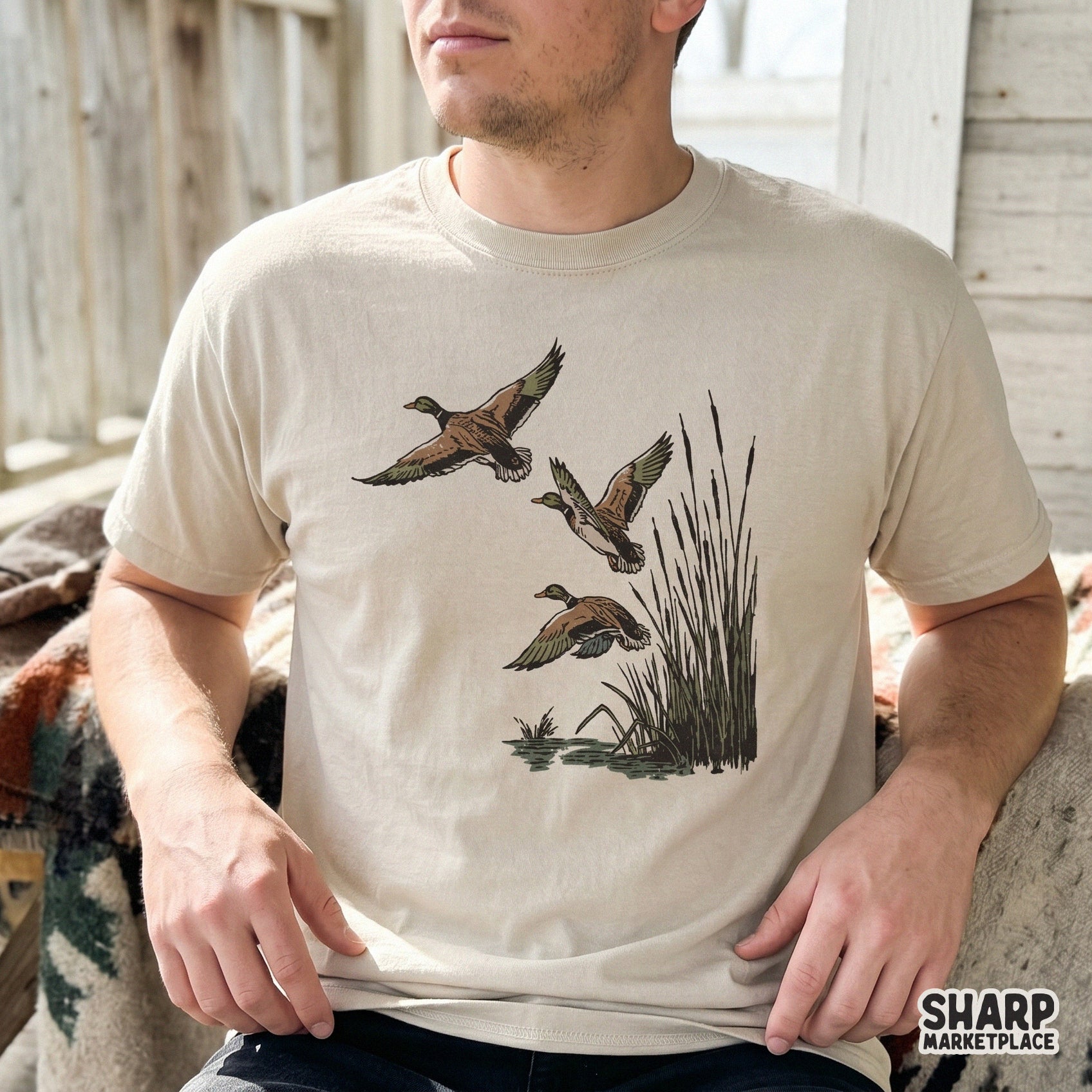 Three mallard ducks in flight above cattails and water, featured as a detailed digital graphic for custom t-shirt sublimation and outdoor decor.