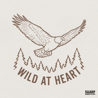 Brown line art of a soaring eagle above a forest silhouette with the text Wild At Heart, perfect for vintage nature-themed apparel and DIY projects.