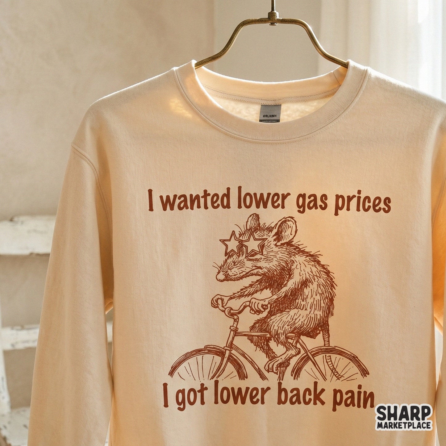 Retro-inspired brown ink illustration of a possum riding a bicycle with funny text about gas prices and back pain for DTF or sublimation printing.