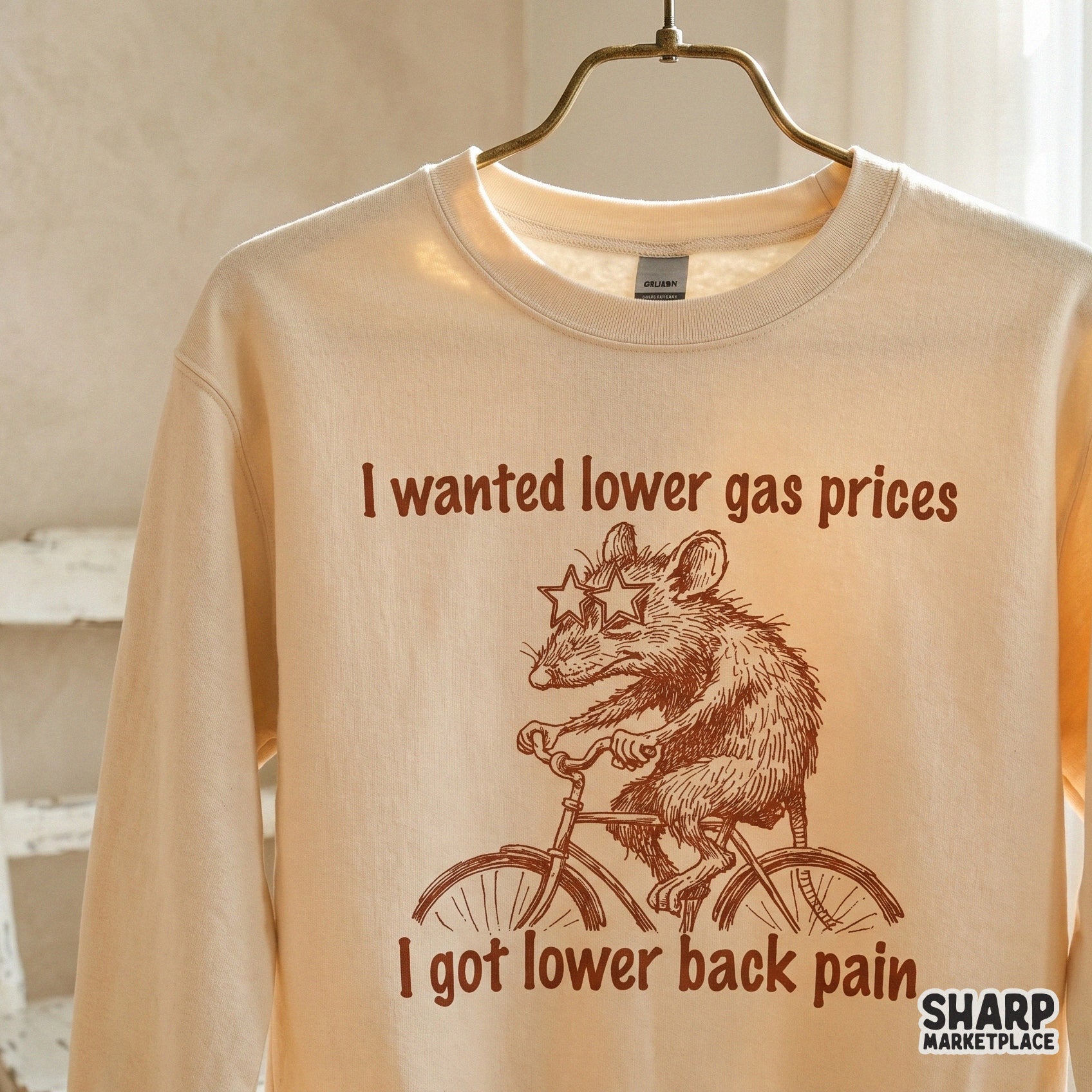 Retro-inspired brown ink illustration of a possum riding a bicycle with funny text about gas prices and back pain for DTF or sublimation printing.