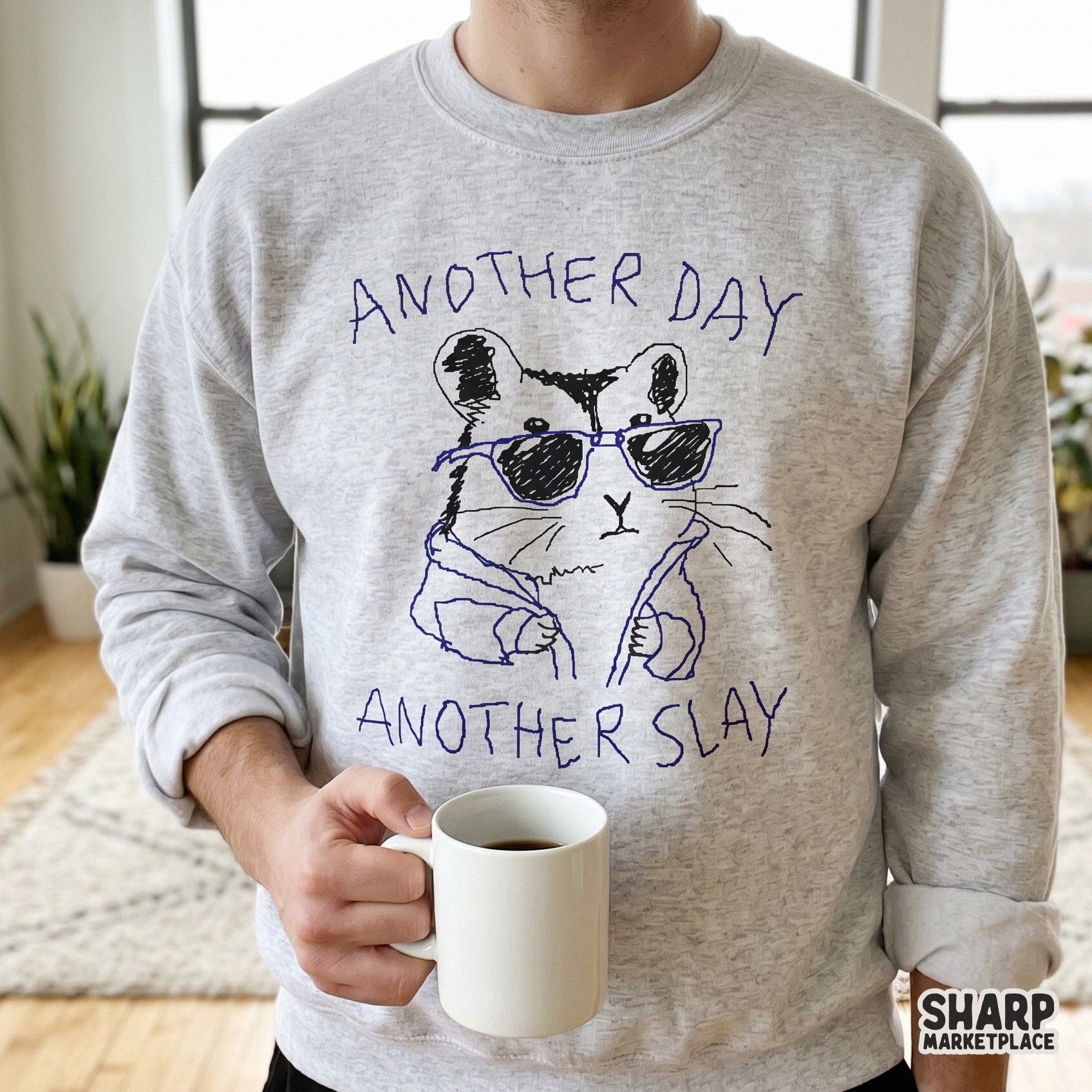 A light gray sweatshirt featuring a funny hand-drawn hamster in sunglasses and a jacket with the text Another Day Another Slay for apparel printing.
