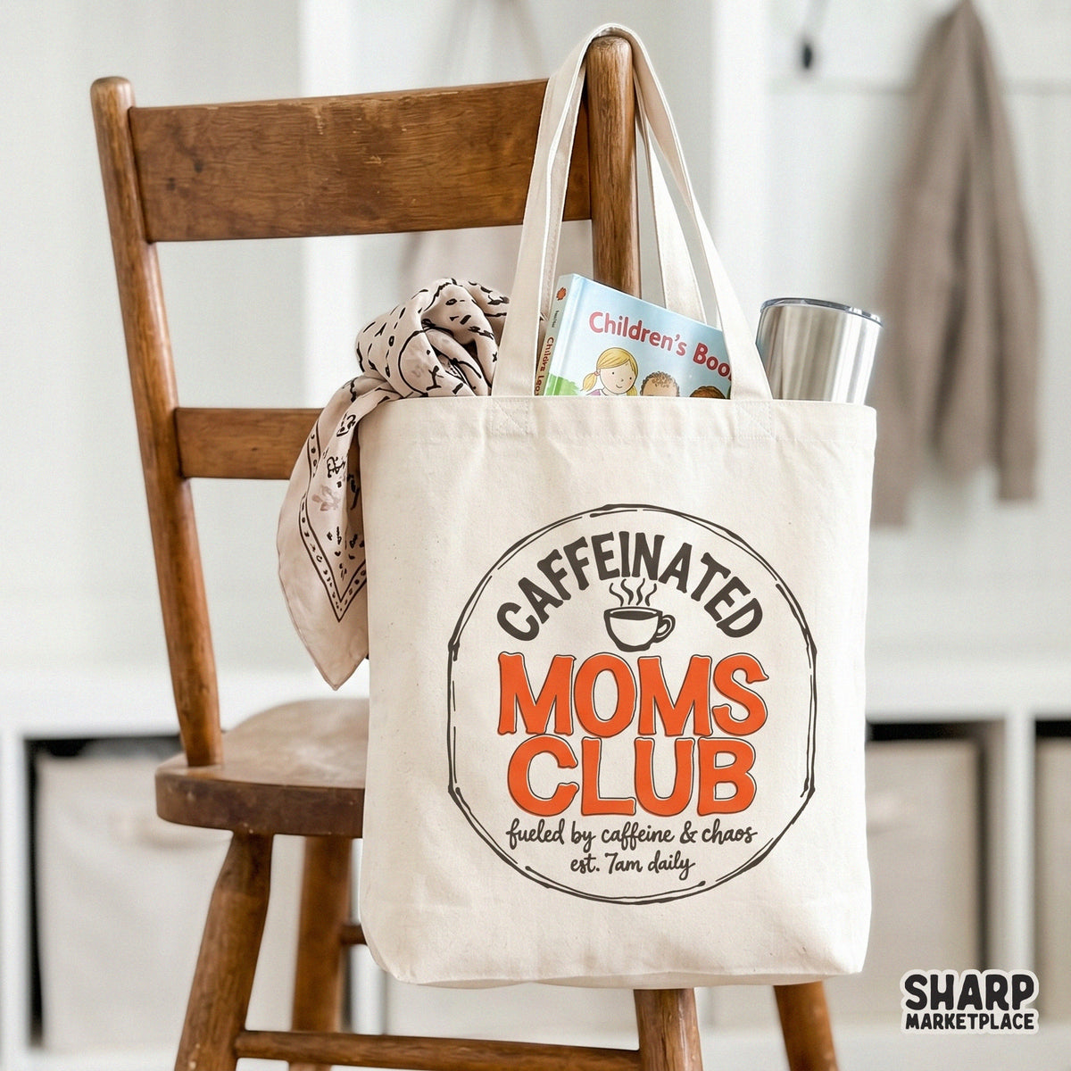 Tote bag mockup displaying a vintage-style coffee emblem with the words Caffeinated Moms Club and fueled by caffeine and chaos est. 7am daily.