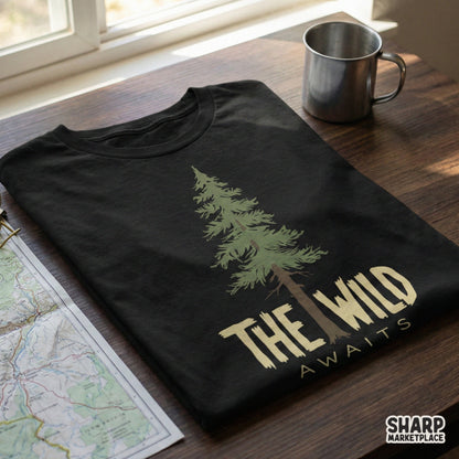 Black t-shirt featuring a detailed evergreen tree graphic and the rugged text The Wild Awaits, ideal for outdoor adventure and camping gear.
