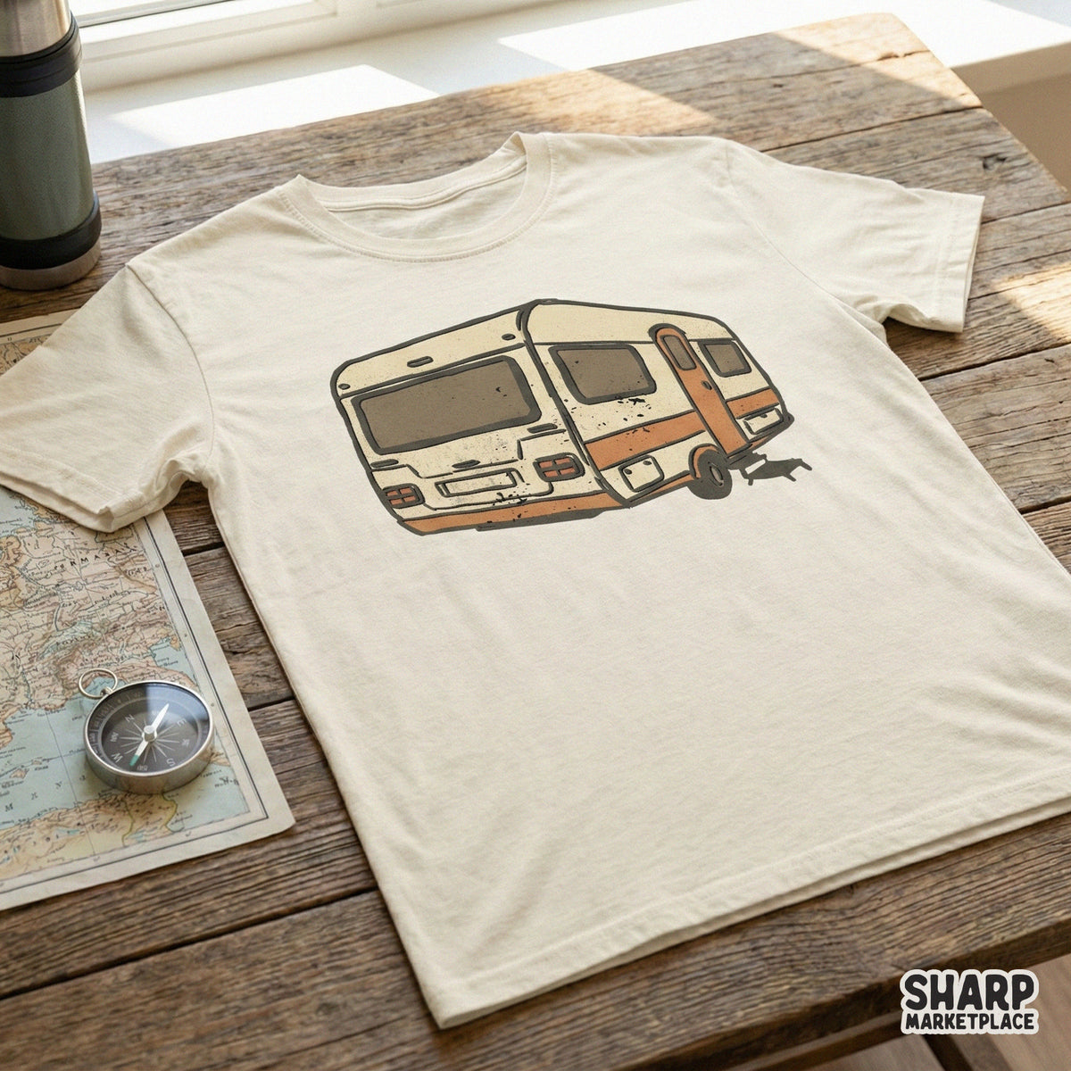 Retro RV trailer digital design printed on a cream t-shirt, showcasing a weathered mid-century camper illustration perfect for outdoor apparel projects.