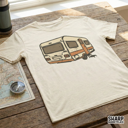 Retro RV trailer digital design printed on a cream t-shirt, showcasing a weathered mid-century camper illustration perfect for outdoor apparel projects.