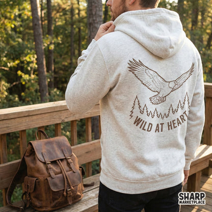 Retro style eagle and forest illustration with Wild At Heart typography, designed as a high-resolution transparent PNG for adventure-themed apparel.