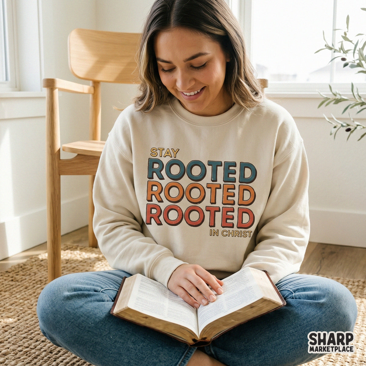 Christian sublimation design featuring stacked text that says Stay Rooted Rooted Rooted In Christ, displayed on a neutral colored sweatshirt.
