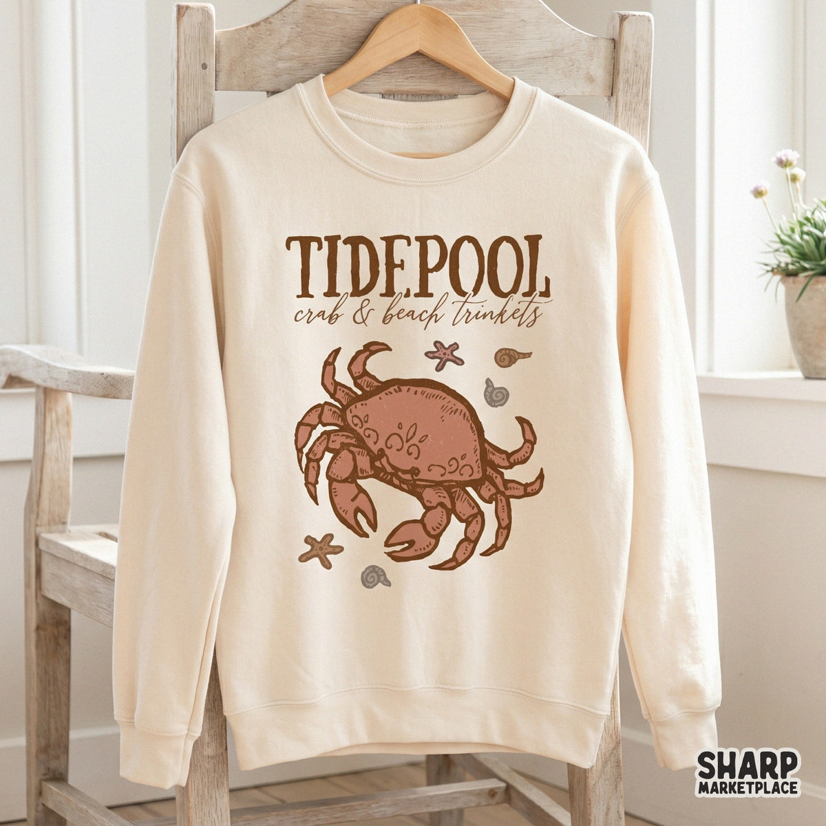 Hand-drawn coastal illustration with vintage serif and cursive text, featuring a crab and beach trinkets for DIY summer crafts and apparel printing.