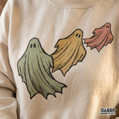Three colorful flying ghosts retro Halloween PNG graphic for spooky season t-shirts and fall shirts