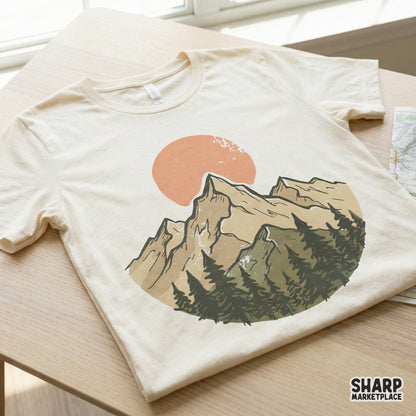 Retro mountain landscape design on a cream t-shirt, showcasing a hand-drawn wilderness scene with a sunset, perfect for outdoor apparel and sublimation.