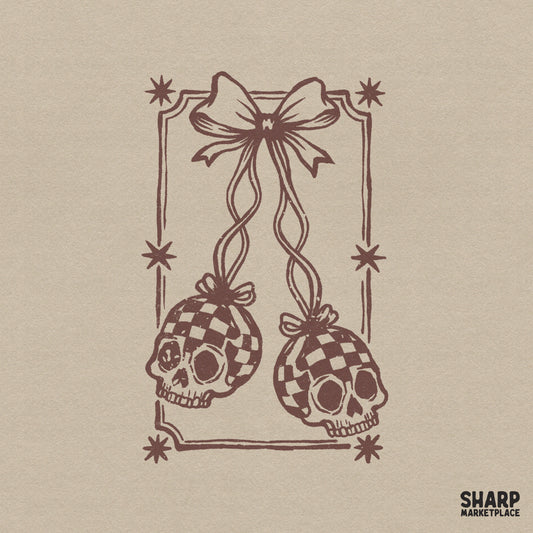 Monochromatic brown line art of two checkered skulls hanging from a delicate bow, framed by a star-accented border in a vintage tattoo style.