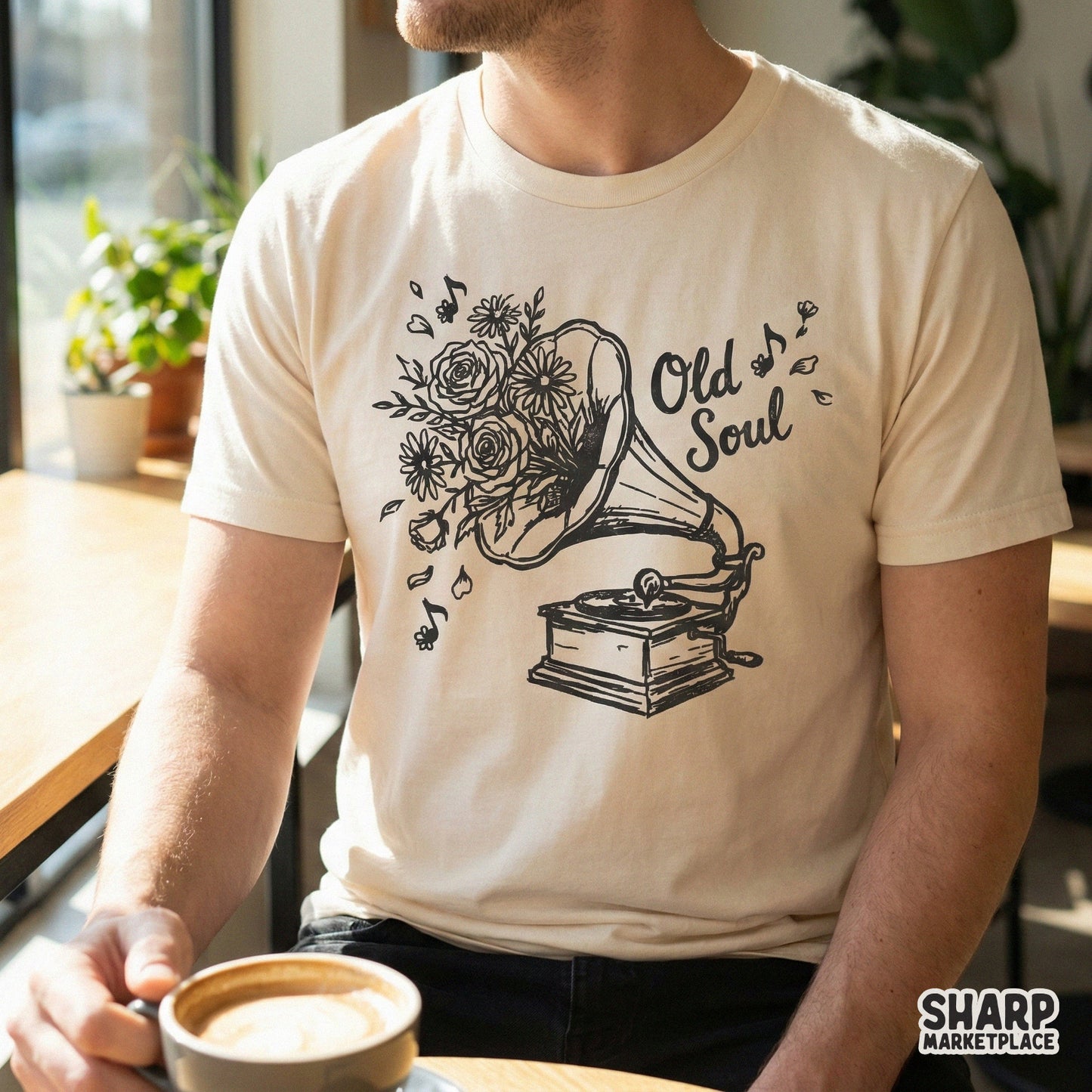 A retro gramophone with blooming flowers and the words Old Soul printed on a cream-colored t-shirt, perfect for vintage-style apparel designs.