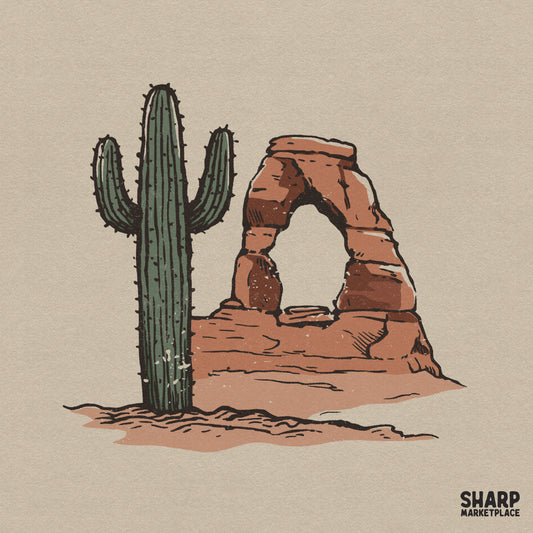 Hand-drawn desert scene digital file featuring a tall saguaro cactus next to a sandstone rock arch in warm terracotta and green tones for apparel.